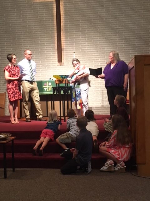 children watching a baptism